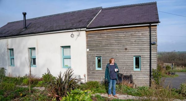 Lillian standing in front of her home